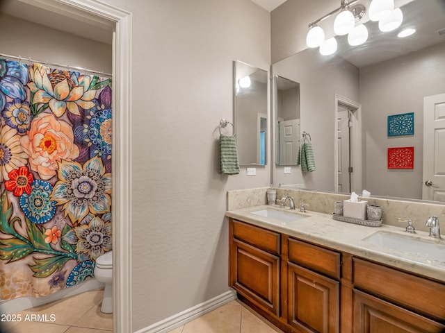 bathroom with toilet, tile patterned flooring, and vanity