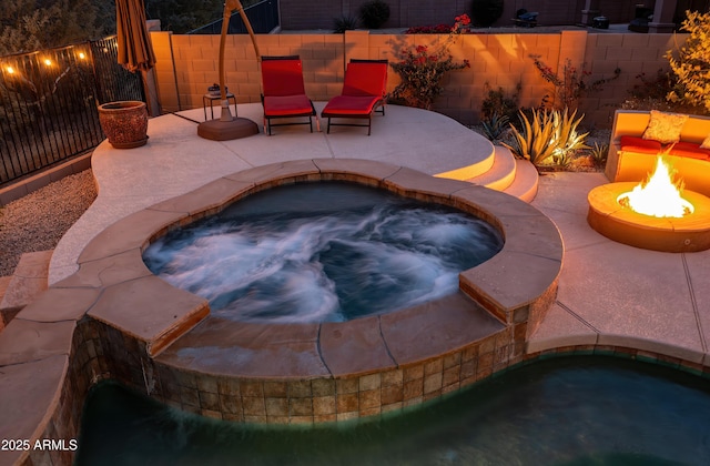 view of pool featuring an outdoor fire pit, a patio area, and an in ground hot tub