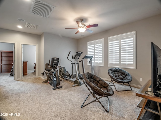 exercise room featuring ceiling fan and light colored carpet