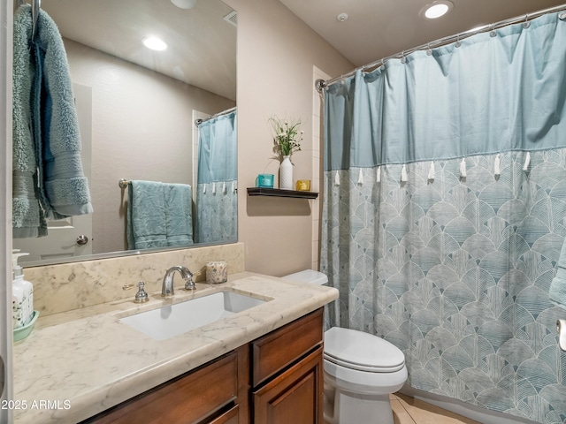 bathroom featuring toilet, a shower with shower curtain, and vanity