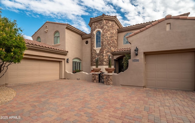 mediterranean / spanish home featuring a garage