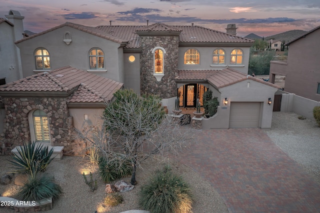 mediterranean / spanish-style home with a garage