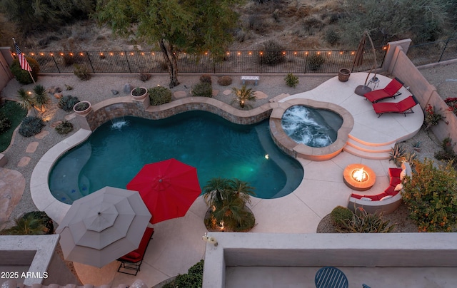 view of pool featuring an outdoor fire pit, an in ground hot tub, and a patio