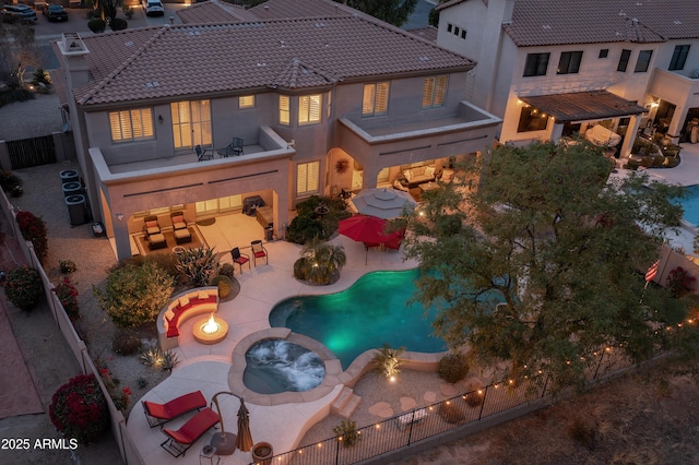 exterior space featuring a pool with hot tub, a patio area, a pergola, and a fire pit