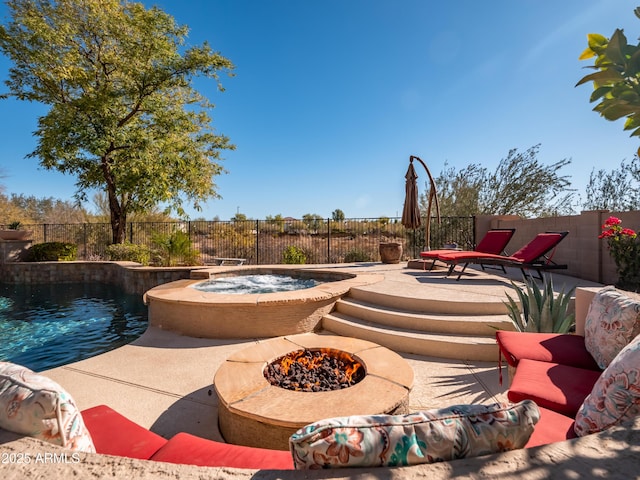 view of pool featuring an in ground hot tub, a fire pit, and a patio