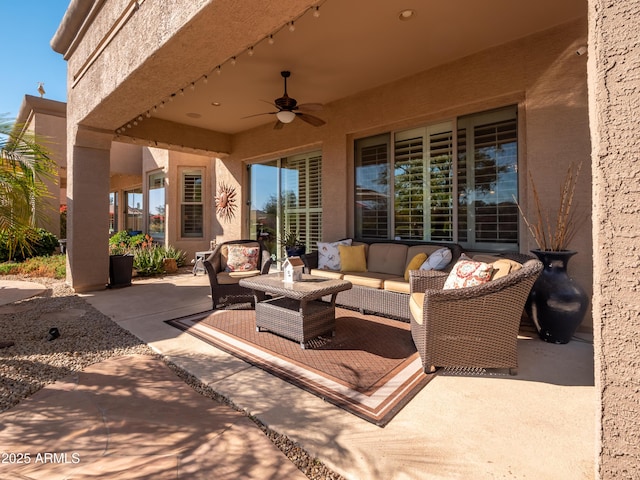 view of patio with ceiling fan and an outdoor living space