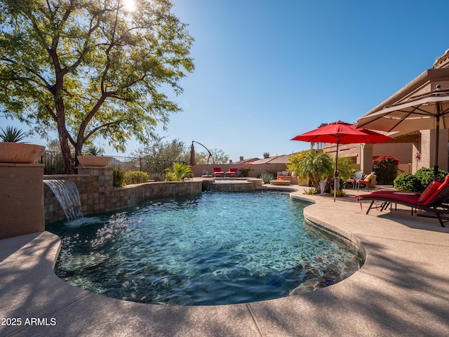 view of pool featuring pool water feature and a patio area