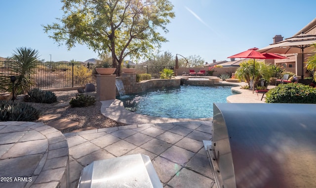 view of swimming pool featuring an in ground hot tub, pool water feature, and a patio