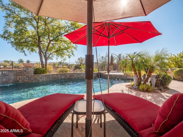 view of swimming pool with pool water feature, a patio area, and a hot tub