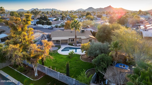 birds eye view of property with a mountain view and a residential view