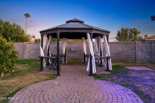 exterior space with a gazebo and a fenced backyard