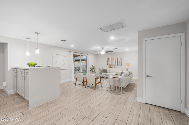 living room featuring visible vents, ceiling fan, baseboards, wood tiled floor, and recessed lighting