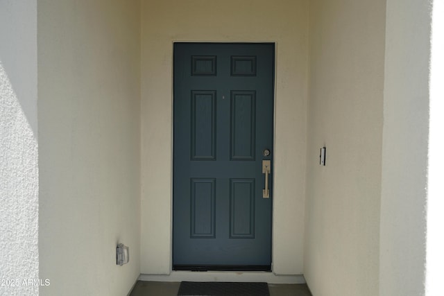 entrance to property with stucco siding