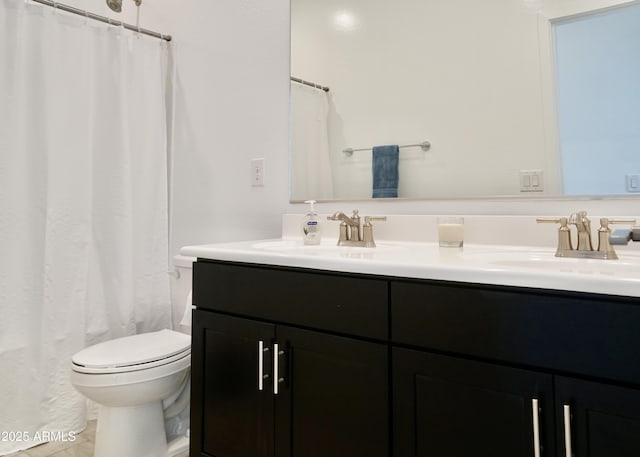 bathroom featuring double vanity, tile patterned flooring, a sink, and toilet