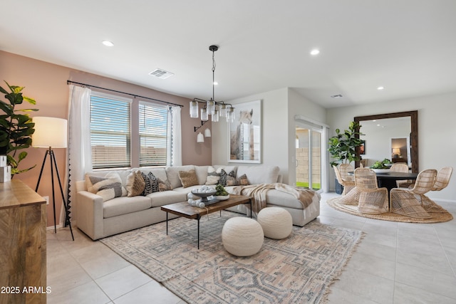 living area with light tile patterned floors, visible vents, and recessed lighting