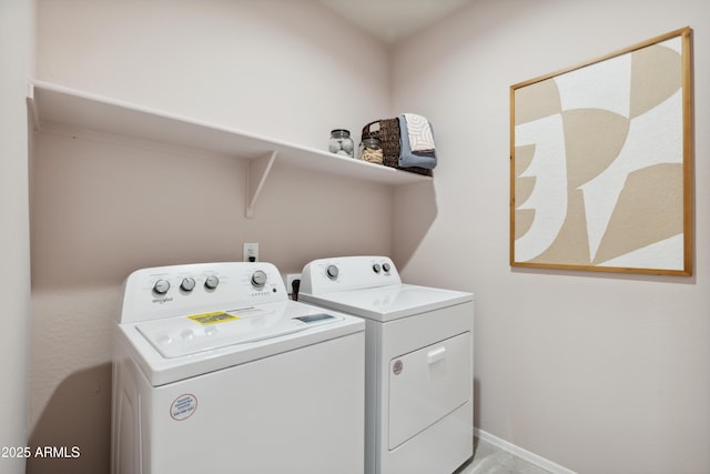 laundry area featuring washer and dryer, laundry area, and baseboards