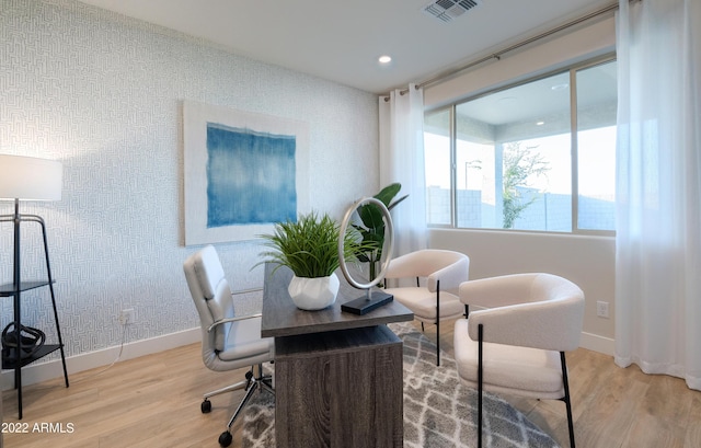 home office with light hardwood / wood-style flooring