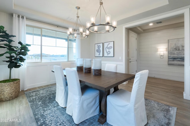 dining area with dark wood-type flooring and a chandelier