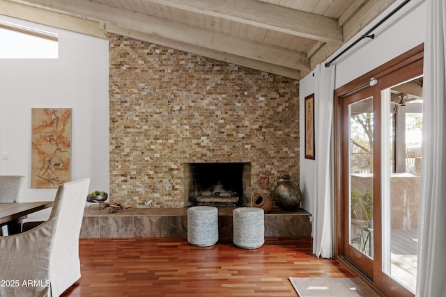 unfurnished living room with vaulted ceiling with beams, wood-type flooring, and wooden ceiling