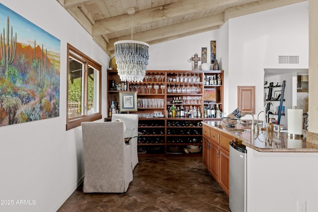 wine cellar featuring vaulted ceiling with beams, sink, a notable chandelier, and wood ceiling