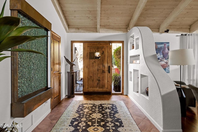 entryway featuring lofted ceiling with beams, light tile patterned flooring, and wood ceiling