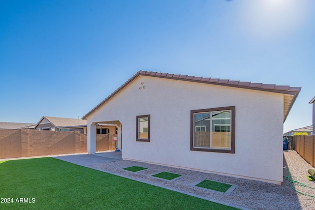 rear view of house with a patio area and a lawn