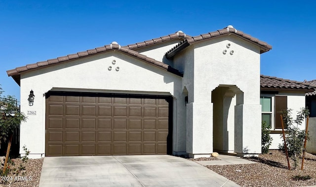 mediterranean / spanish house featuring a garage