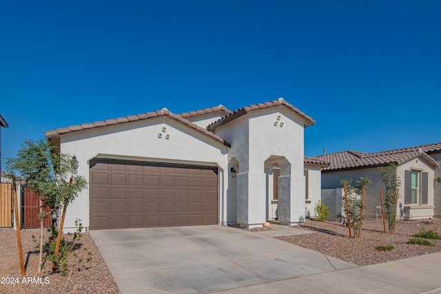 mediterranean / spanish-style home with a garage