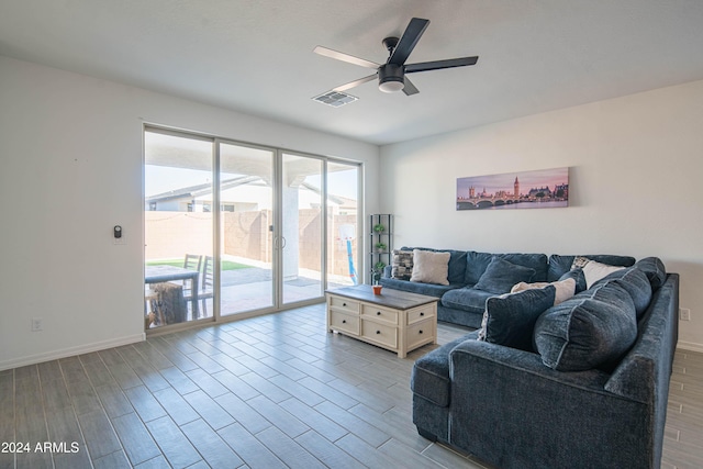 living room featuring ceiling fan and light hardwood / wood-style floors