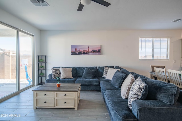 living room with ceiling fan and light wood-type flooring