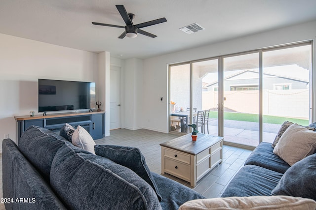 living room with light wood-type flooring and ceiling fan