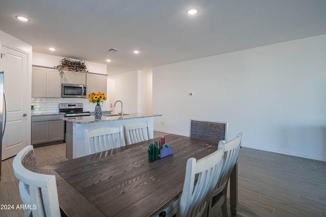 dining space featuring dark hardwood / wood-style floors and sink