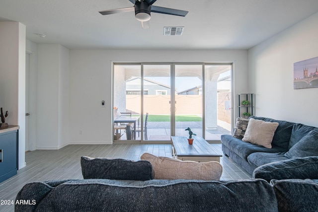 living room with light wood-type flooring and ceiling fan