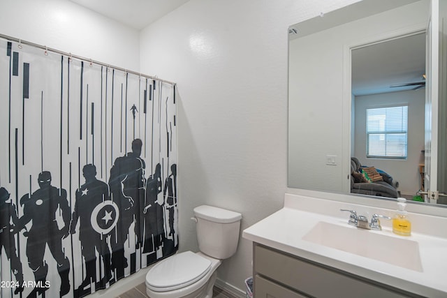 bathroom with vanity, ceiling fan, and toilet