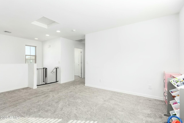 4110 S 58th Ln, Phoenix, AZ 85043 - carpeted empty room with attic access, baseboards, and visible vents