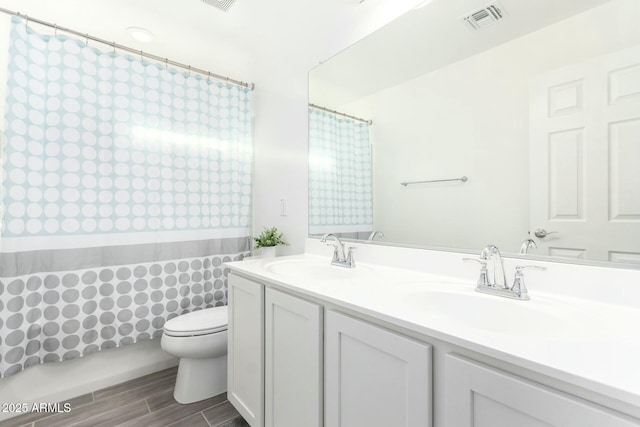 4110 S 58th Ln, Phoenix, AZ 85043 - bathroom with a sink, visible vents, toilet, and wood tiled floor