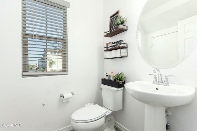 4110 S 58th Ln, Phoenix, AZ 85043 - bathroom with a sink, baseboards, and toilet