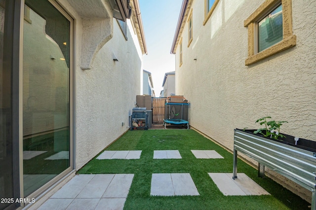 4110 S 58th Ln, Phoenix, AZ 85043 - view of yard featuring a trampoline and fence