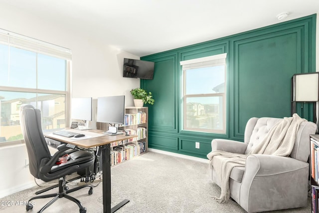 home office featuring carpet floors and a decorative wall