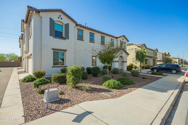 4110 S 58th Ln, Phoenix, AZ 85043 - view of front facade with a tile roof, a garage, a residential view, and stucco siding