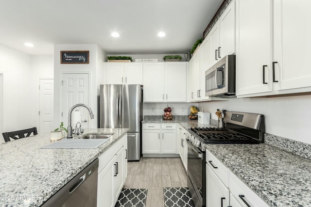 4110 S 58th Ln, Phoenix, AZ 85043 - kitchen featuring recessed lighting, white cabinets, stainless steel appliances, and a sink
