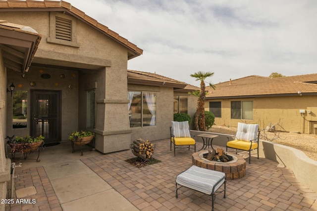 view of patio with an outdoor fire pit