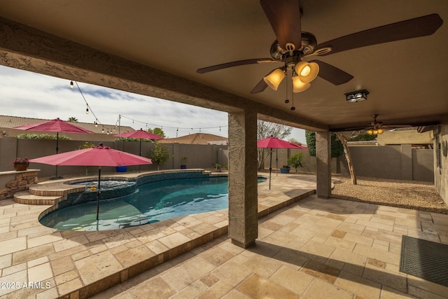 view of swimming pool featuring an in ground hot tub, ceiling fan, and a patio area