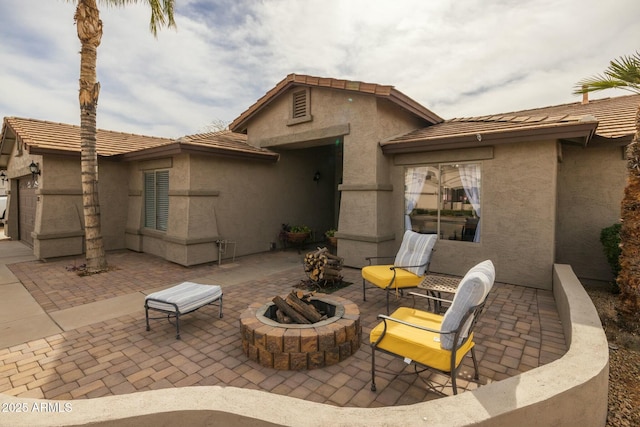 view of patio with a fire pit