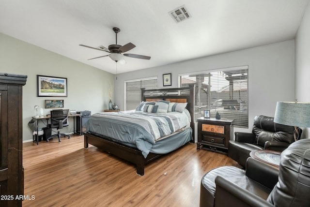 bedroom with hardwood / wood-style flooring, ceiling fan, and vaulted ceiling