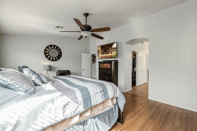 bedroom with lofted ceiling, ceiling fan, and light hardwood / wood-style flooring