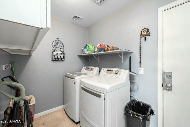 laundry area featuring cabinets and washer and dryer