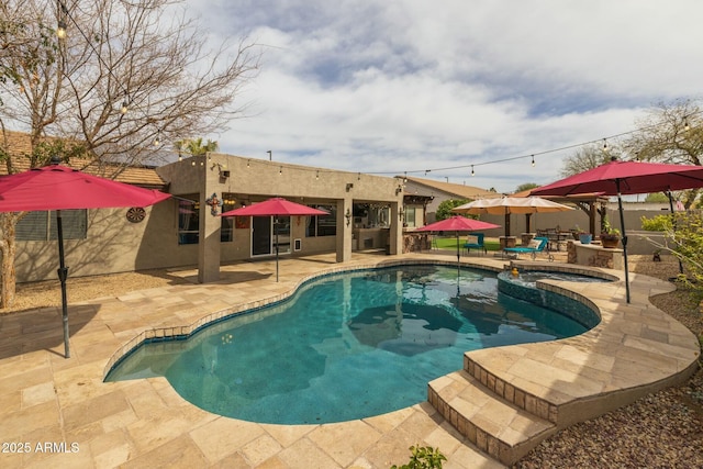 view of pool featuring an in ground hot tub and a patio area