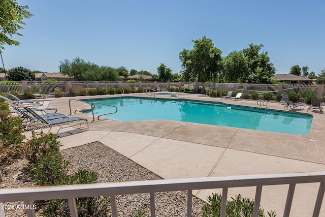 view of swimming pool featuring a community hot tub and a patio area