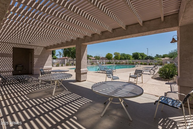 view of patio / terrace with a community pool and a pergola